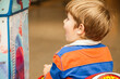 © Austockphoto - Little boy playing on kiddie ride at the supermarket