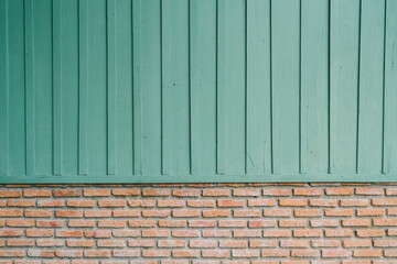 Poster - Green background. Textured Wooden Wall Above Light Brick Base with Green Paint for Creative Backgrounds and Design Inspiration