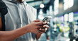 © peopleimages.com - Hands, smartphone and man in gym, fitness and health with digital app for progress. Person, mobile user and athlete in wellness center, cellphone and social media with exercise, network or chatting