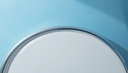 Poster - Elegant round mirror with thin metallic frame against a serene blue backdrop