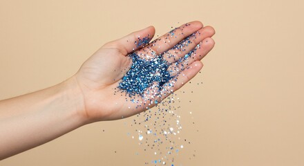Poster - Hand holding shower of blue silver glitter confetti sparkles