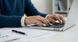 © Arx PhotoStock - Person typing on laptop keyboard at office desk