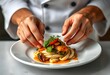 © Reandz - A Close-Up of a Chef's Hands Delicately Plating a Beautifully Prepared Gourmet Meal