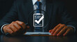 © Grid Byte Studio - Businessman pressing virtual checklist icon on tablet representing task approval and productivity