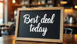 © Vladimir - Best deal today sign on wooden table in cafe setting