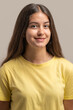 © Lomb - Simple and direct studio headshot of a smiling young woman.