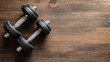 © Chingiz - Flat lay of vinyl dumbbells on a wooden surface with space available for accompanying text