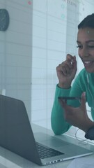 Poster - Animation of stock market data processing over african american woman having video call on laptop