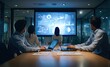 © Gamenin - Four business professionals seated around a large conference table, facing a large screen displaying dynamic data visualizations in a dimly lit modern office at night