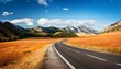 © Dusty - scenic mountain landscape with road orange fields and light blue sky illustrates travel adventure exploration and the beauty of nature