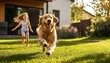 © Thunyarat - Golden Retriever joyfully playing with children in lush green yard.