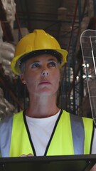 Poster - Animation of data processing on screen over caucasian woman working in warehouse