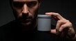 © Baiqvivit - Serious Man Holding a Gray Supplement Jar Mockup  High-Resolution Product Photography