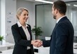 © Havoc - Business people shaking hands in an office with smiling expressions