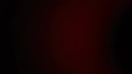 Poster - A dark gradient background transitions from deep black to a vibrant, blurred red hue