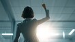 © AI-HAL8 - ガッツポーズをする女性ビジネスパーソンの後ろ姿｜挑戦,勝利,前進,モチベーション,自信