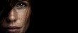 © Fernando - Intense closeup portrait of a White woman with freckles and striking green eyes, conveying raw emotion and natural beauty against a dark background