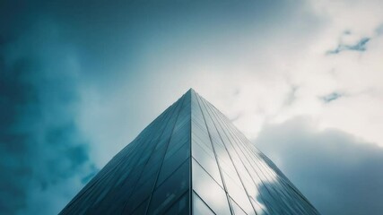 Aufkleber - A modern glass skyscraper standing tall against a bright blue sky, ideal for corporate or business uses