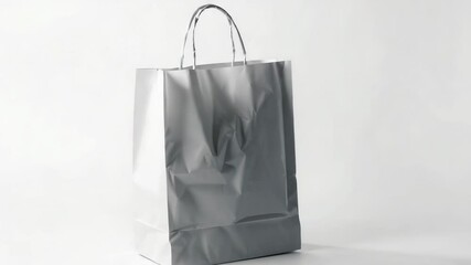 Aufkleber - A single white paper bag sitting on a plain white surface