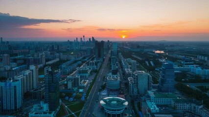Poster - Aerial view of a city skyline at sunset with vibrant colors and shadows
