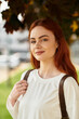 © Bliss - Beautiful young woman enjoying a sunny day outdoors with a light smile and casual elegance