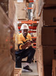 © Nassorn - Warehouse manager, store inspector checking stock on storage shelf from inventory checklist. Two diverse ethnic people wear safety hard hat working together examining merchandise at distribution store