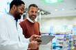 © bnenin - Two Professionals Collaborating and Using a Tablet in a Modern Pharmacy