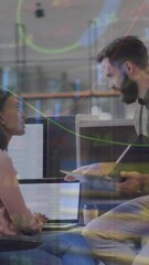 Poster - Animation of graphs, trading board and loading circles over diverse coworkers discussing on desk