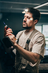 Poster - Craftsman working with a power drill in a modern workshop during daylight hours