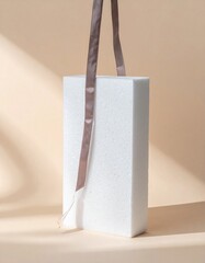 Aufkleber - White Rectangular Block with Brown Ribbon on Beige Background