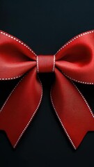 Poster - A simple yet striking image of a bright red bow set against a dark black background