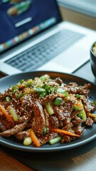 Poster - A plate of food sits next to a laptop, perfect for a snack or meal break while working or studying