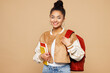 © ViDi Studio - Young smiling happy teen girl student she wear casual clothes backpack bag hold book look camera isolated on plain pastel light beige background studio portrait High school university college concept