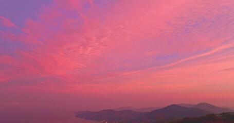 Wall Mural - aerial view of pink sky above the island. bird eye view captures the beauty of the pink sky as it sl