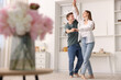 © New Africa - Happy young couple dancing together at home, low angle view