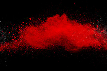 Wall Mural - red powder explosion on black background. colored cloud. colorful dust explode. paint holi