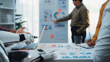 Poster - A modern office scene depicting a collaborative environment where professionals engage in data analysis using technology. A robotic arm is showcased, symbolizing innovation.Noogenesis