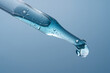 © ADDICTIVE STOCK - Cosmetic pipette with blue liquid close up