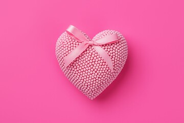 Poster - Pink heart-shaped box with white polkdots and pink ribbon tied in bow on top.