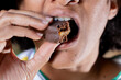 © Paula - Young woman eating Brazilian honey cake