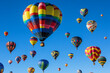 © pavlofox - Colorful hot air balloons fill the sky during a lively festival