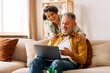© Home-stock - Weekend pastime. Senior spouses using laptop, man and woman surfing Internet or shopping online together