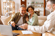 © Home-stock - Male realtor consulting senior couple buyers showing project on laptop, man and woman clients buy house from agency. Rental concept