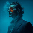 © Photo tiime - A stylish man in a retro pinstripe suit poses confidently in moody blue lighting, wearing tinted sunglasses. Swirling smoke surrounds him, adding a cinematic and mysterious atmosphere.