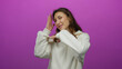 © Krakenimages.com - Woman gesturing playfully against vibrant pink background wearing white sweater with relaxed hairstyle and cheerful expression conveying positivity and youthful energy.