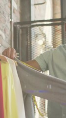 Poster - Video of trails of lights over man measuring cloths