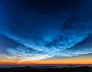 Wall Mural - bright noctilucent clouds shimmer in electric blue tones above the fading orange twilight creating a rare and ethereal high altitude atmospheric display