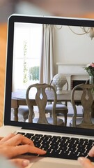 Poster - Woman using laptop with modern dining room interiors displayed on screen