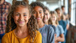 © Elena - Group of smiling girls with curly hair standing in a line in a bright indoor environment