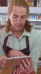 Poster - Animation of graphs and currency signs over caucasian man and woman discussing over tablet in store